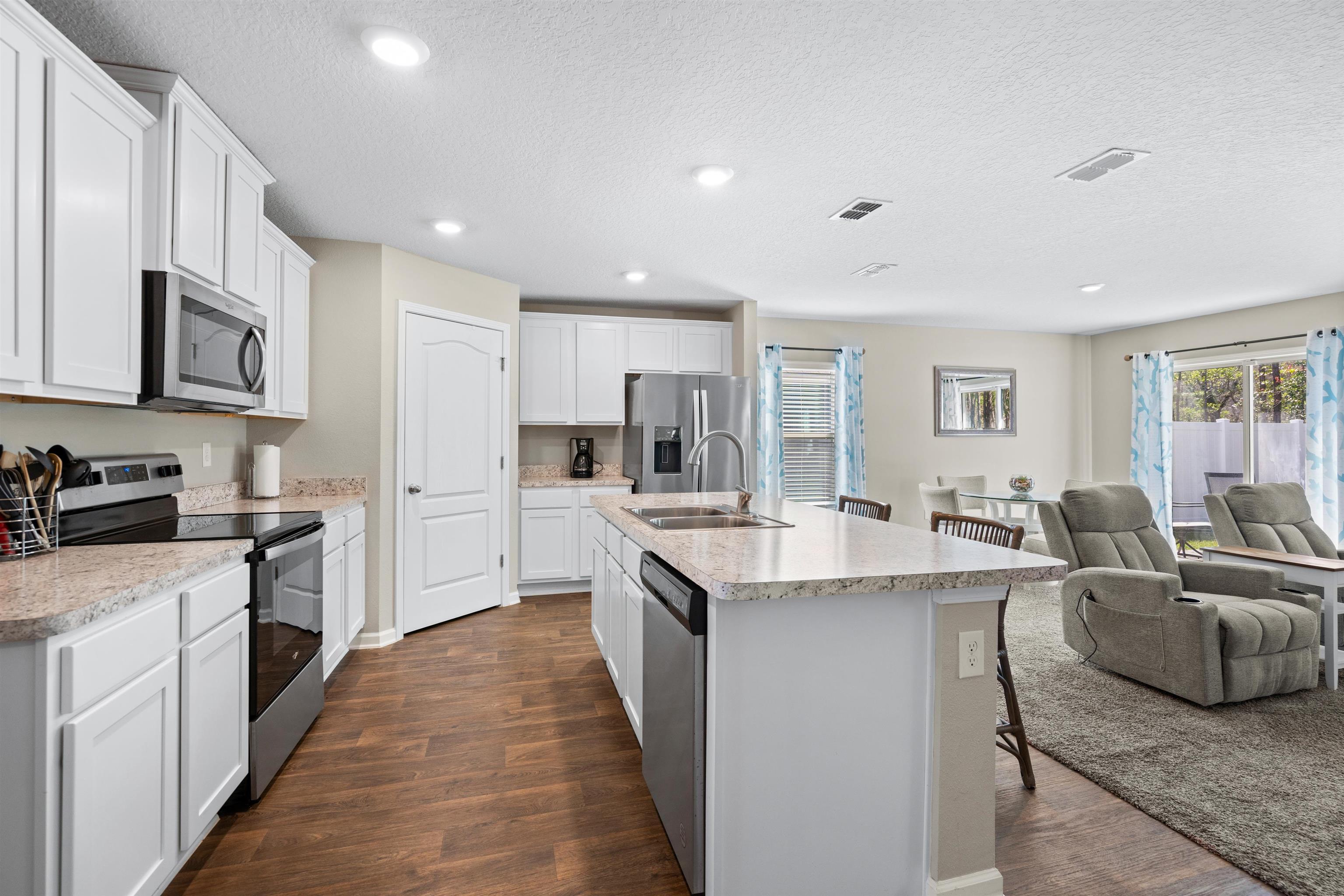 408 Falcon Ridge Road St. Augustine, FL 32084 - Photo 8 of 26 a large kitchen with stainless steel appliances lots of white cabinets