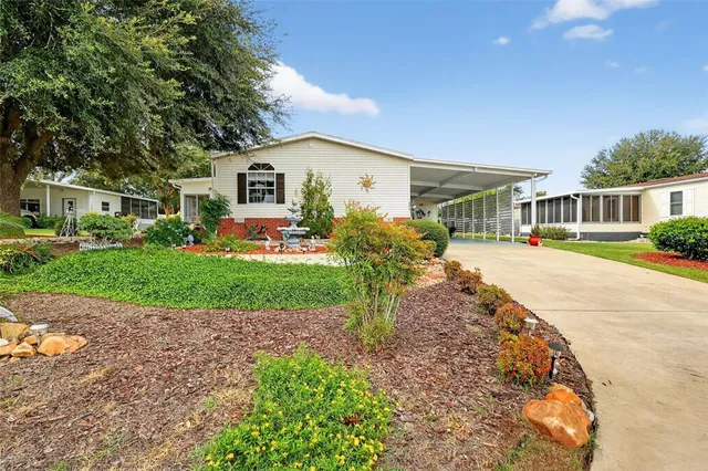 a front view of a house with a yard and outdoor seating