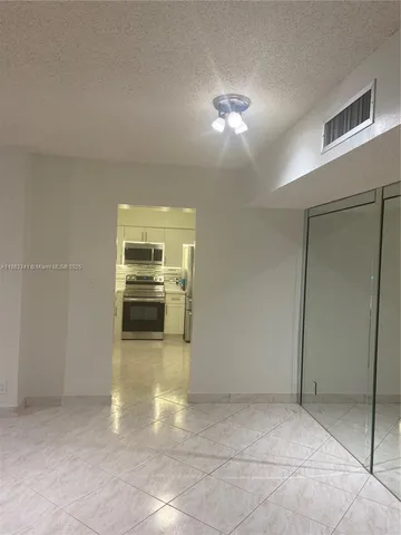a view of a hallway with a kitchen