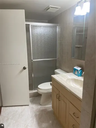 a white toilet sitting next to a bathroom sink