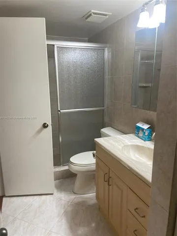 a white toilet sitting next to a bathroom sink