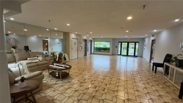 a lobby with furniture and a rug
