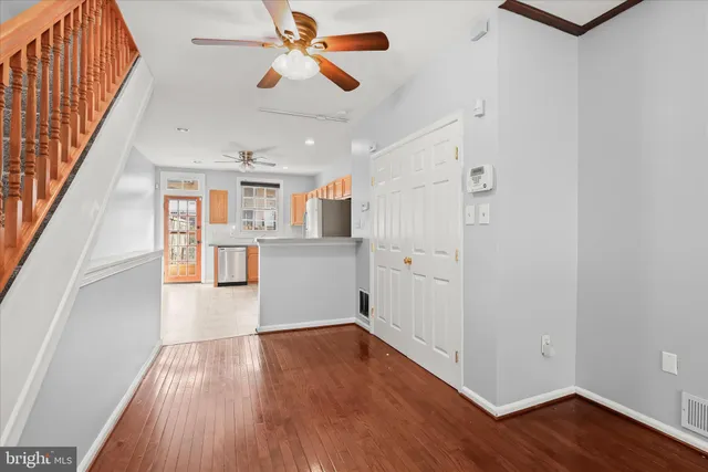 a view of a kitchen with wooden floor and window