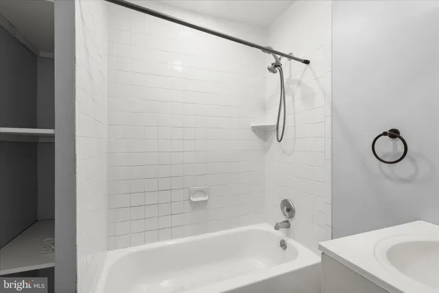 a bathroom with a white bath tub and a shower