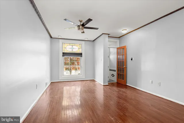 wooden floor in an empty room with a window