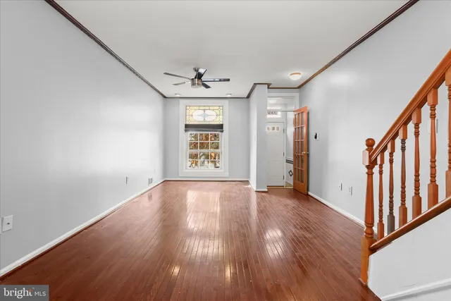 wooden floor in an empty room with a window
