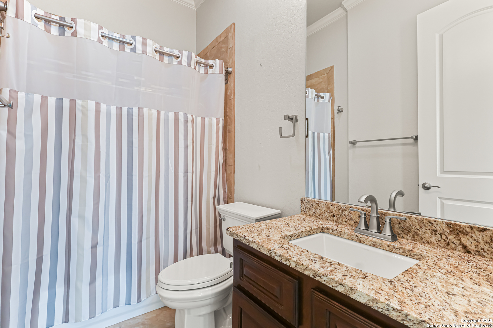919 Sutters Rim San Antonio, TX 78258 - Photo 15 of 27 a bathroom with a granite countertop sink a toilet and a mirror