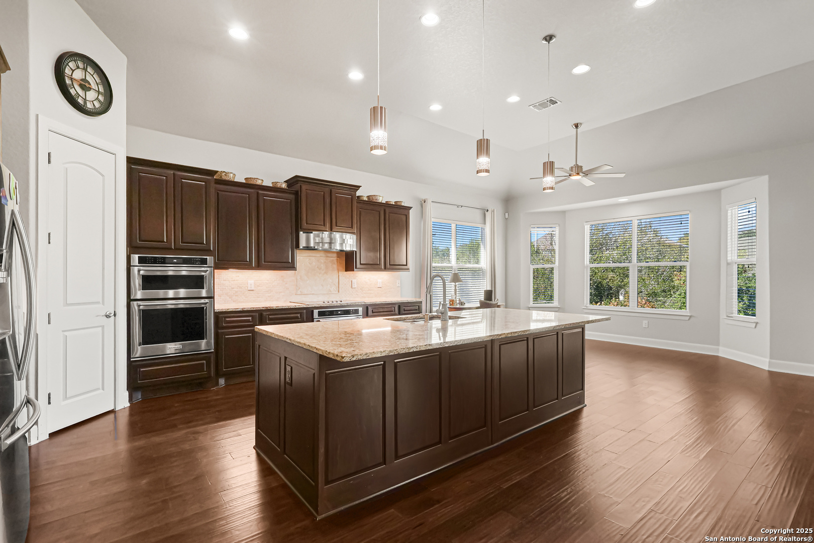 919 Sutters Rim San Antonio, TX 78258 - Photo 27 of 27 a kitchen with stainless steel appliances granite countertop a sink a stove and a wooden floors