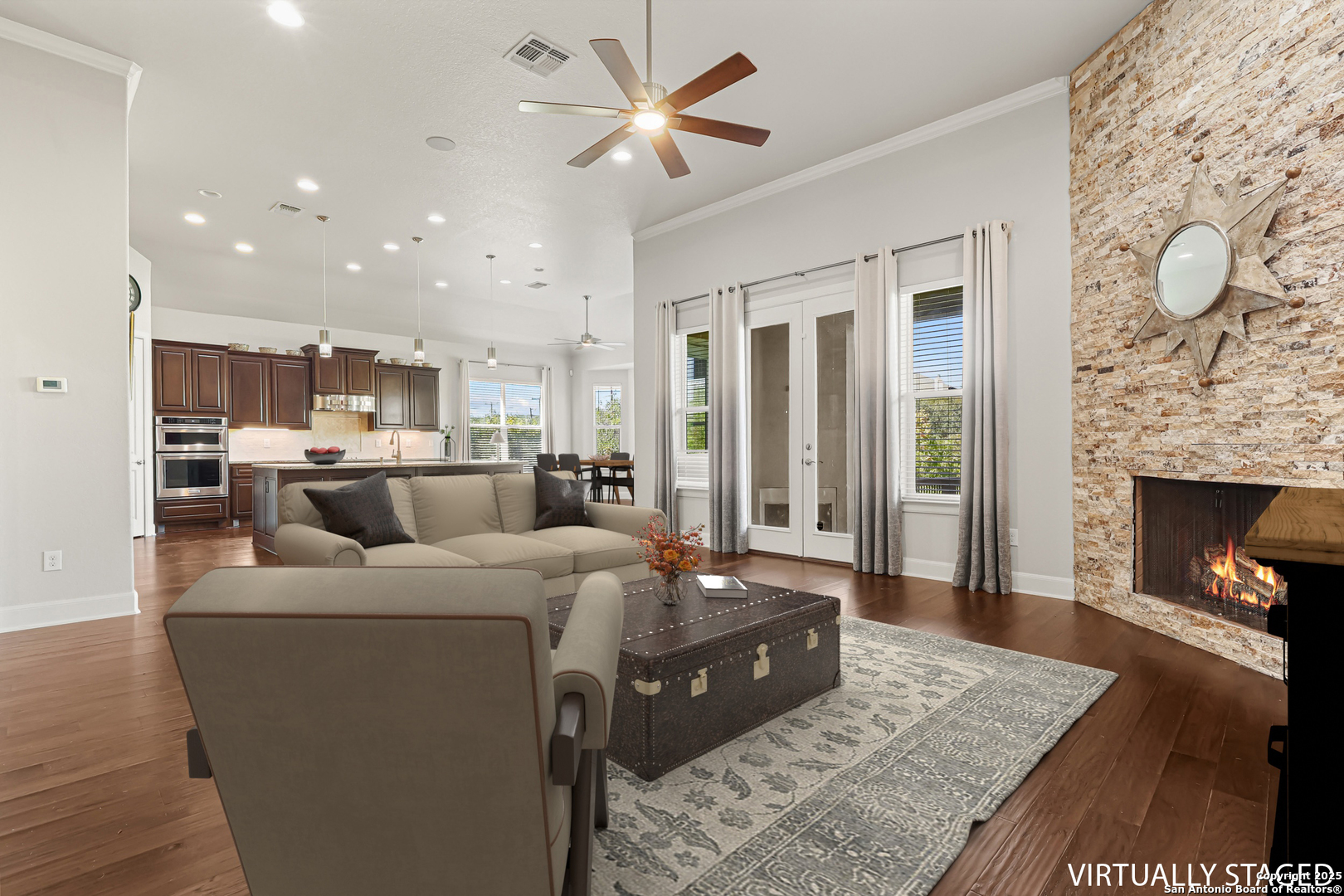 919 Sutters Rim San Antonio, TX 78258 - Photo 8 of 27 a living room with furniture a fireplace and a flat screen tv