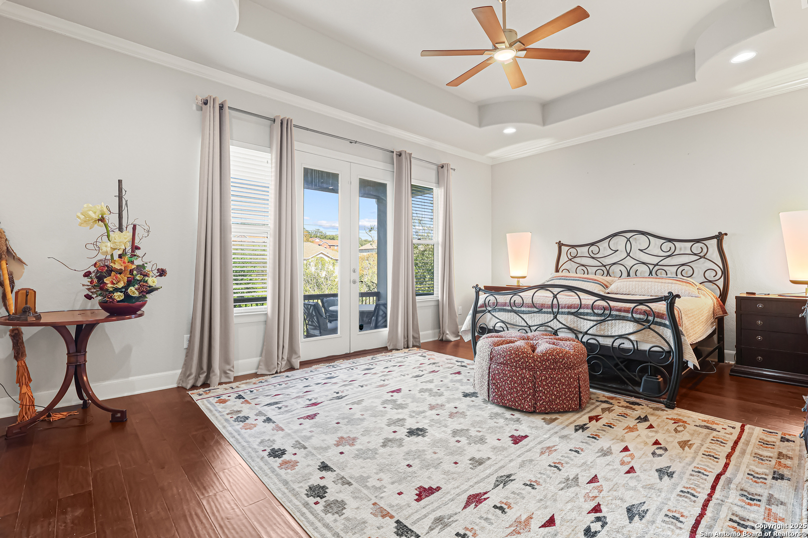 919 Sutters Rim San Antonio, TX 78258 - Photo 9 of 27 a bedroom with a bed and a chandelier