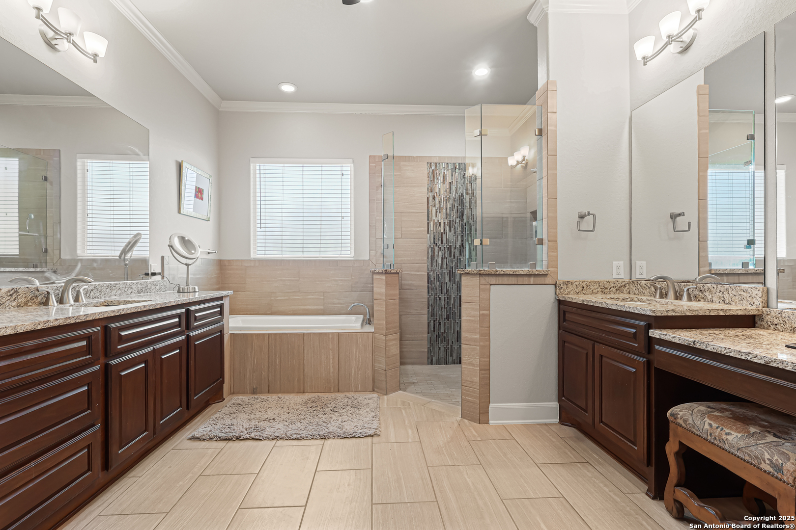 919 Sutters Rim San Antonio, TX 78258 - Photo 10 of 27 a large bathroom with a granite countertop double vanity sink a mirror and a bathtub