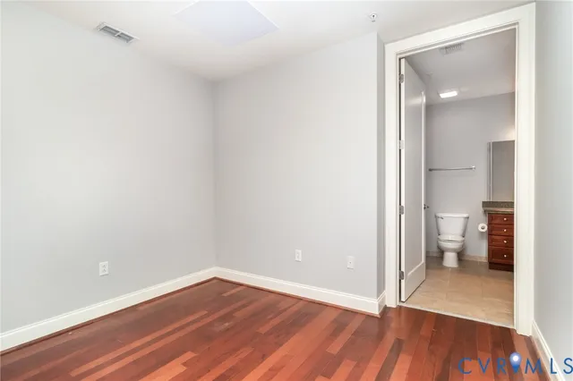a view of a room with wooden floor