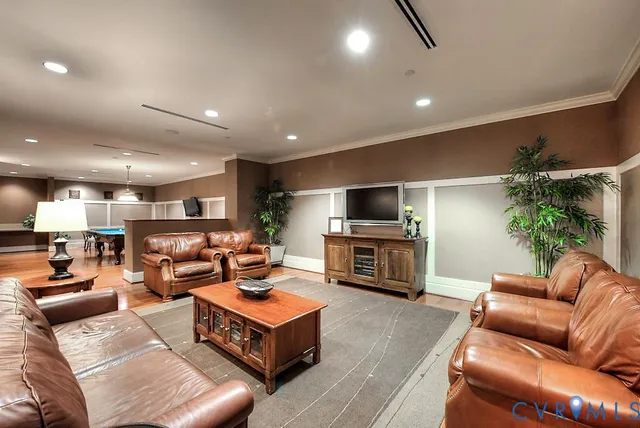 a living room with dining room and wooden floor