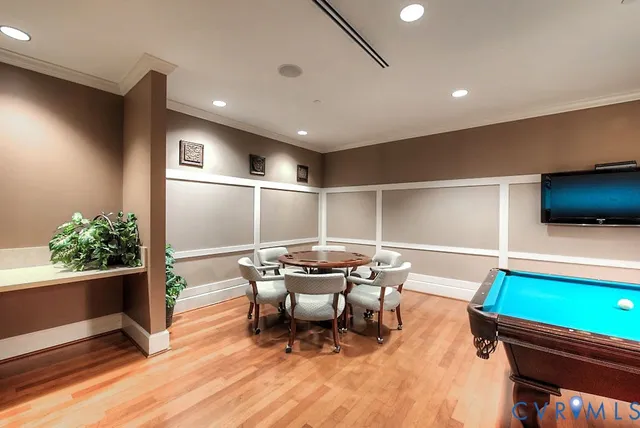 a room with wooden floor and furniture