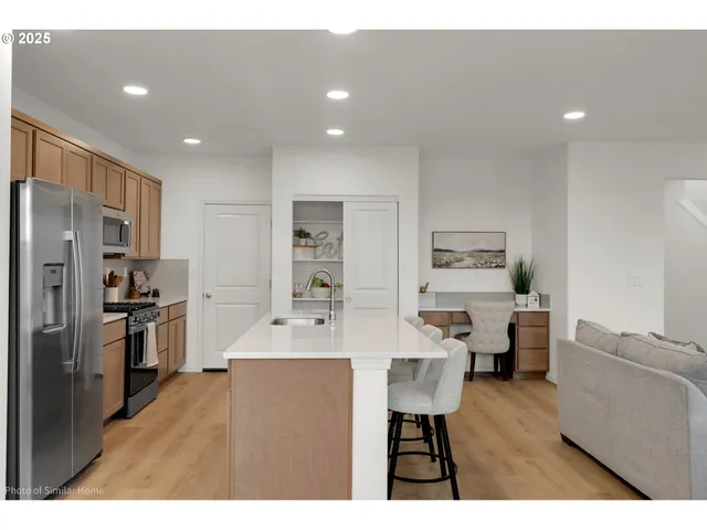 a large kitchen with a table and chairs