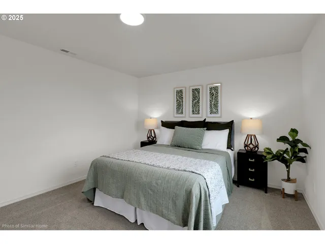 a bedroom with a bed and a lamp