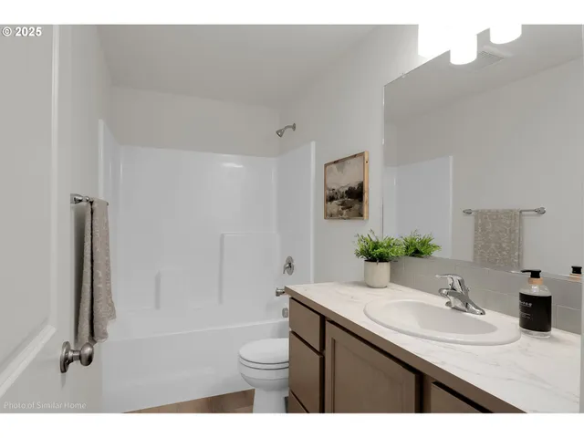 a bedroom with a bed and a night stand