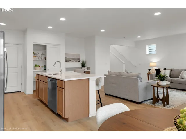 a living room with a sink cabinets and kitchen view