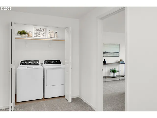 a living room with stainless steel appliances furniture a dining table and kitchen view