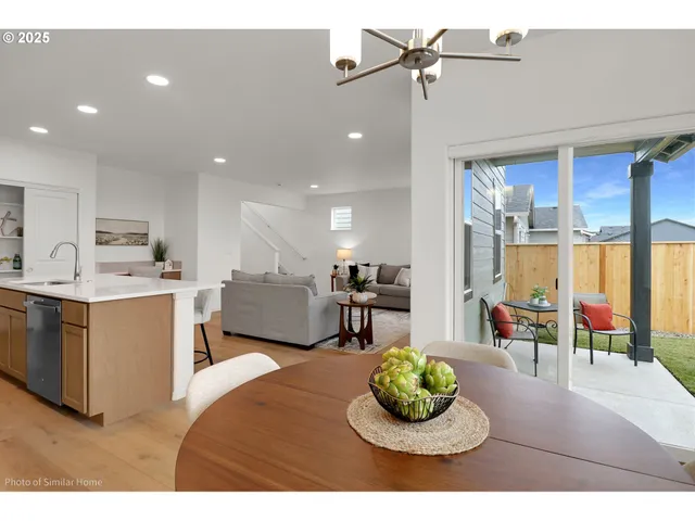 a living room with stainless steel appliances kitchen island furniture and a view of kitchen