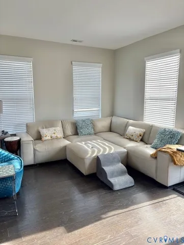 a bedroom with furniture and wooden floor