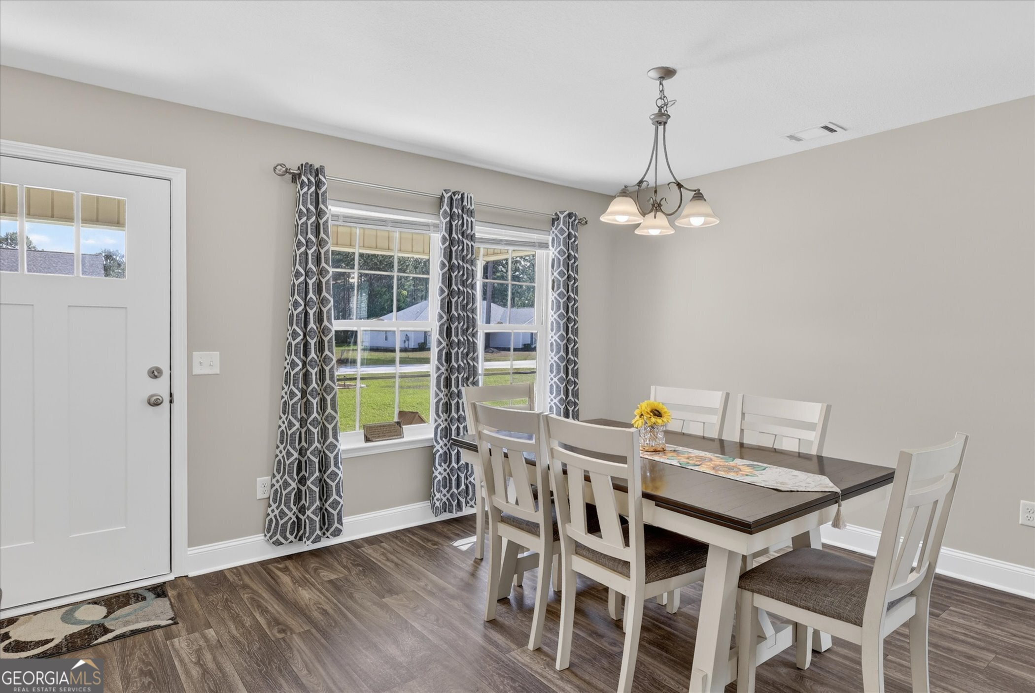 164 Stonebrook Way Statesboro, GA 30458 - Photo 11 of 46 a dining room with furniture a chandelier and wooden floor