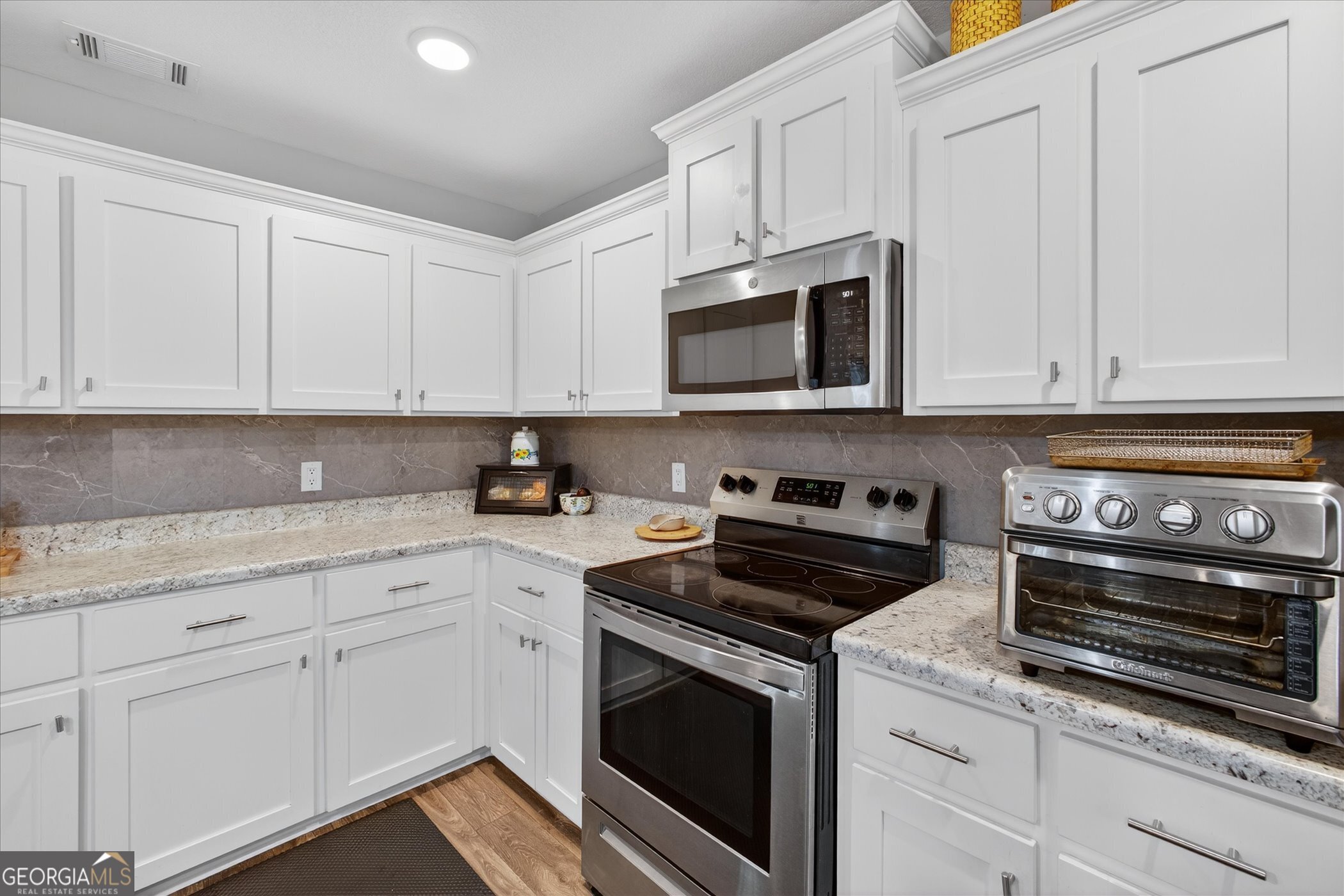 164 Stonebrook Way Statesboro, GA 30458 - Photo 14 of 46 a kitchen with granite countertop white cabinets and stainless steel appliances