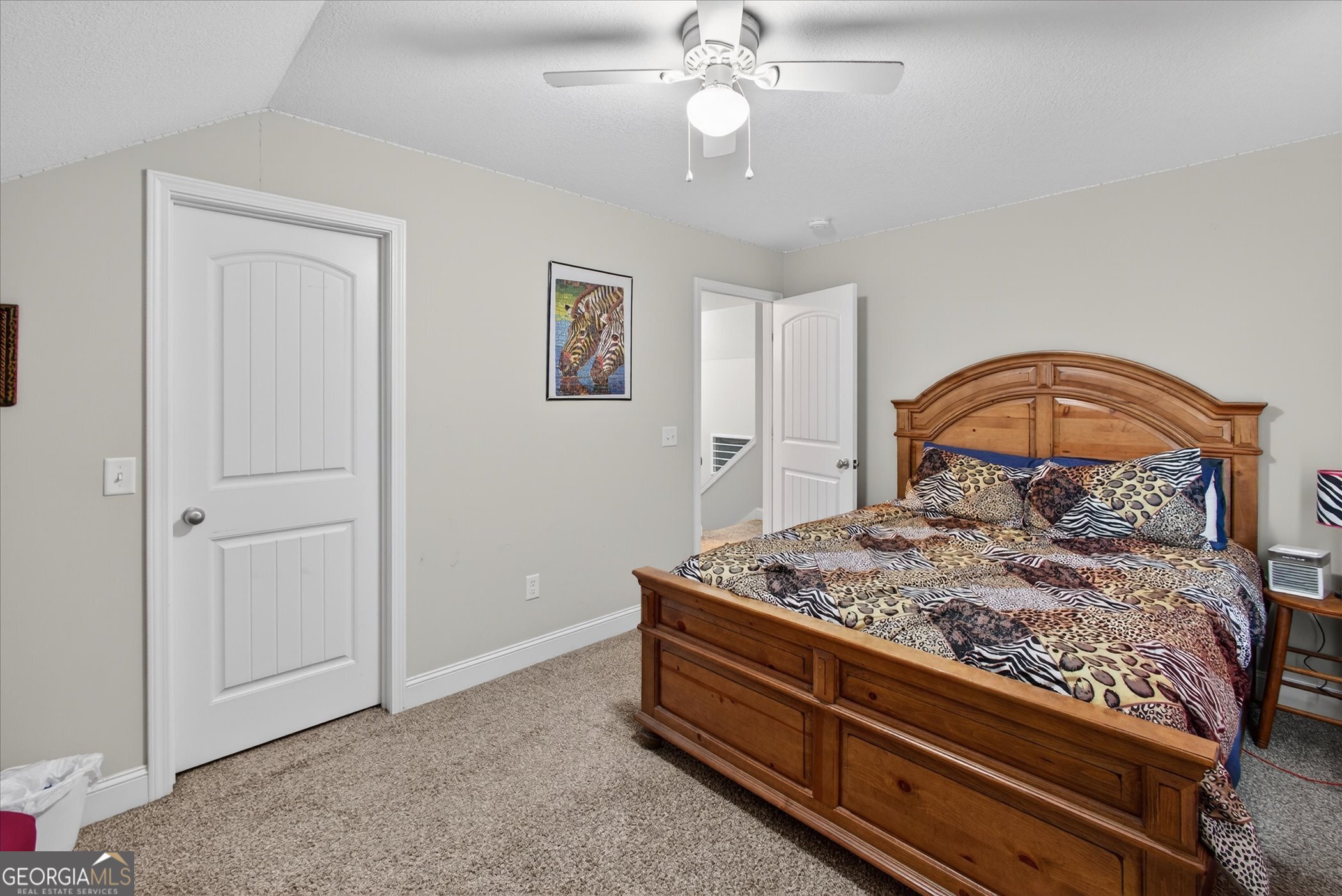 164 Stonebrook Way Statesboro, GA 30458 - Photo 28 of 46 a bedroom with a bed and a chandelier