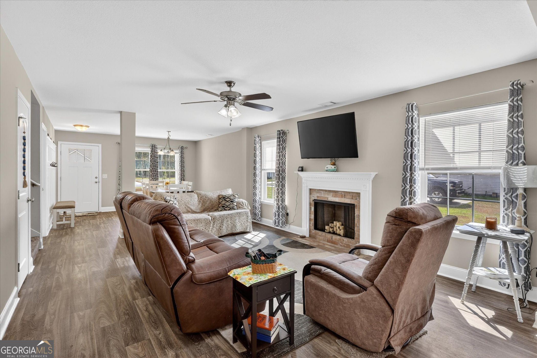 164 Stonebrook Way Statesboro, GA 30458 - Photo 6 of 46 a living room with furniture a fireplace and a flat screen tv