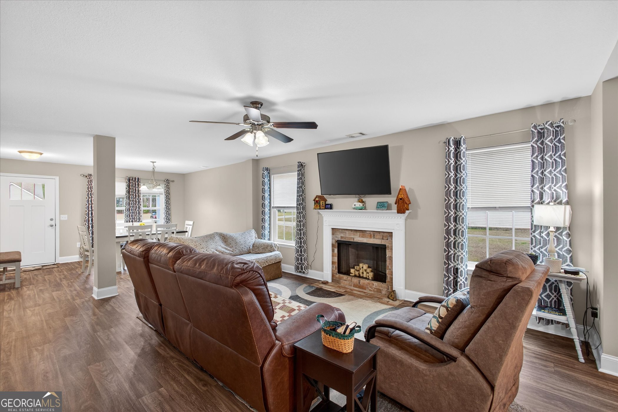 164 Stonebrook Way Statesboro, GA 30458 - Photo 7 of 46 a living room with furniture a fireplace and a flat screen tv