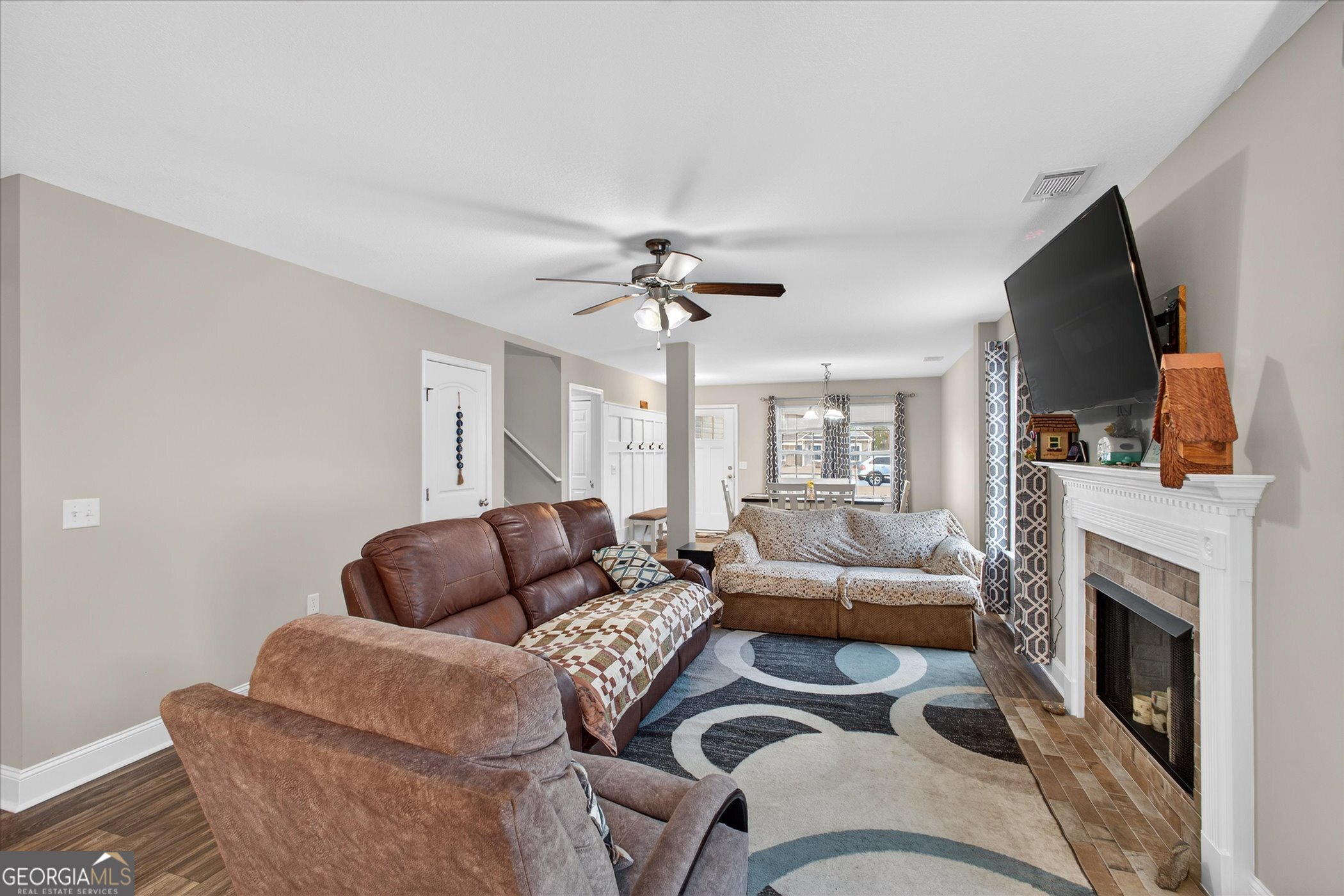 164 Stonebrook Way Statesboro, GA 30458 - Photo 8 of 46 a living room with furniture a flat screen tv and a fireplace
