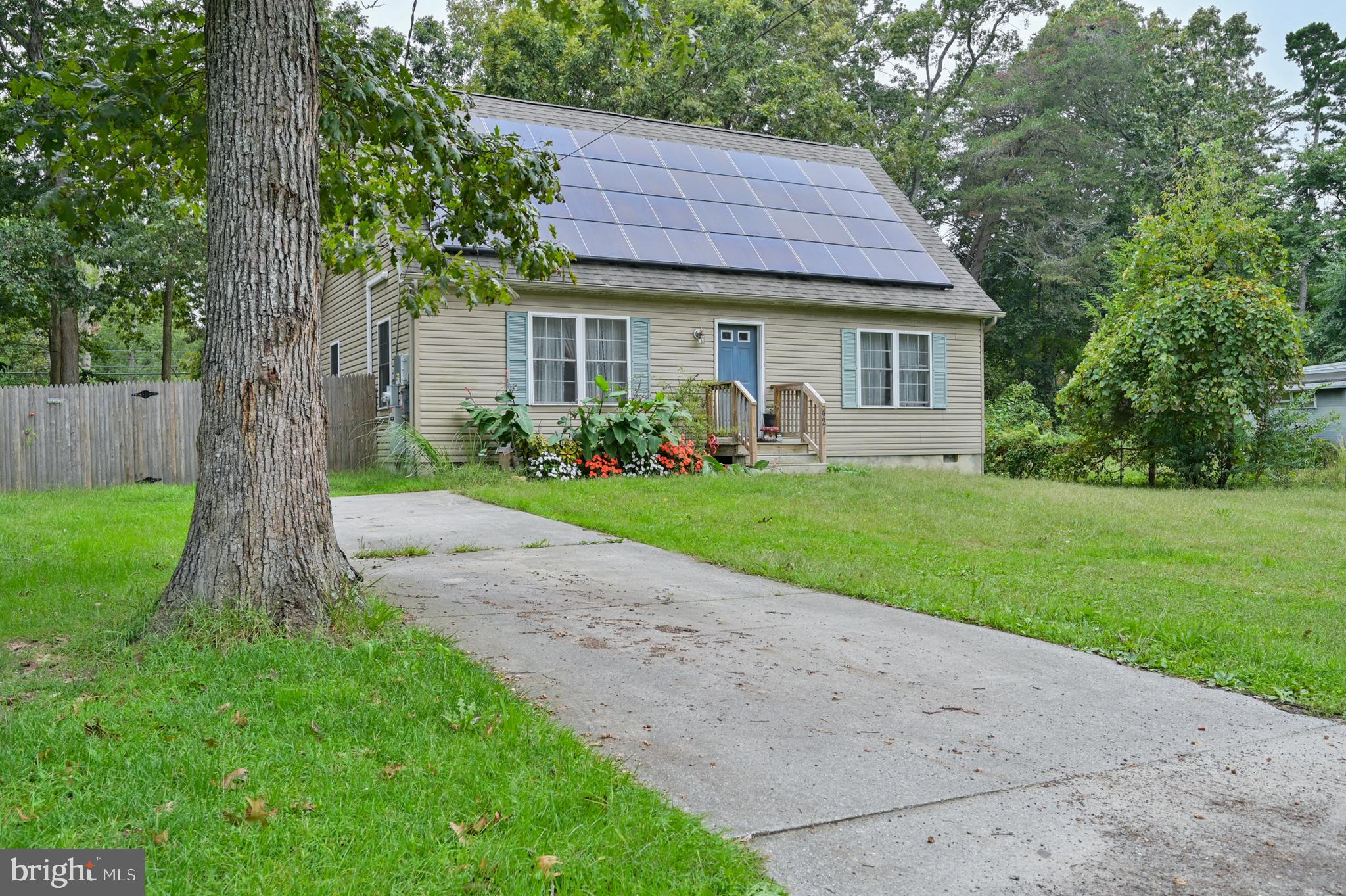 421 Evergreen Road Millville, NJ 08332 - Photo 17 of 26 a front view of a house with a yard and trees
