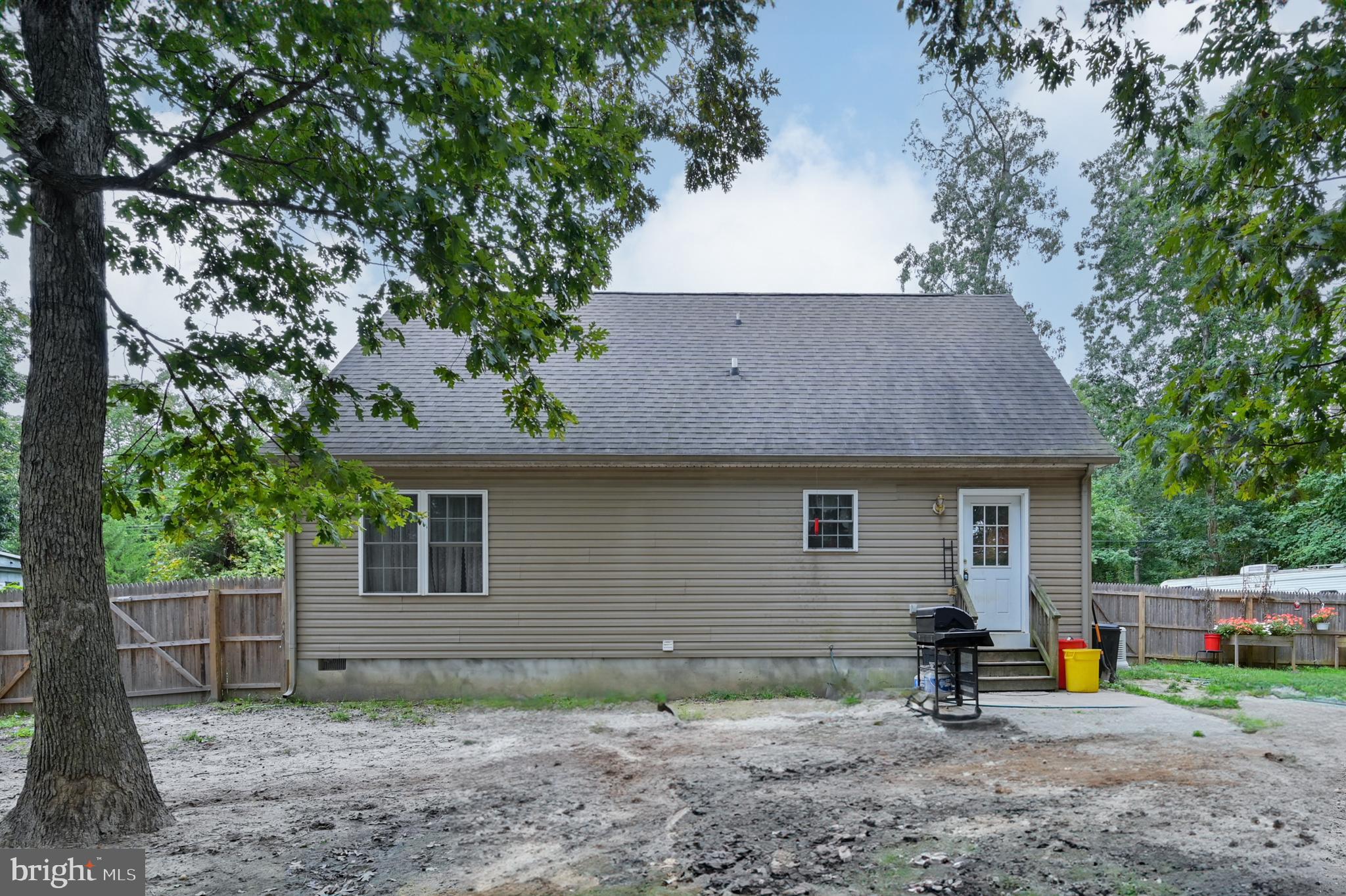 421 Evergreen Road Millville, NJ 08332 - Photo 26 of 26 a backyard of a house with wooden fence and a tree