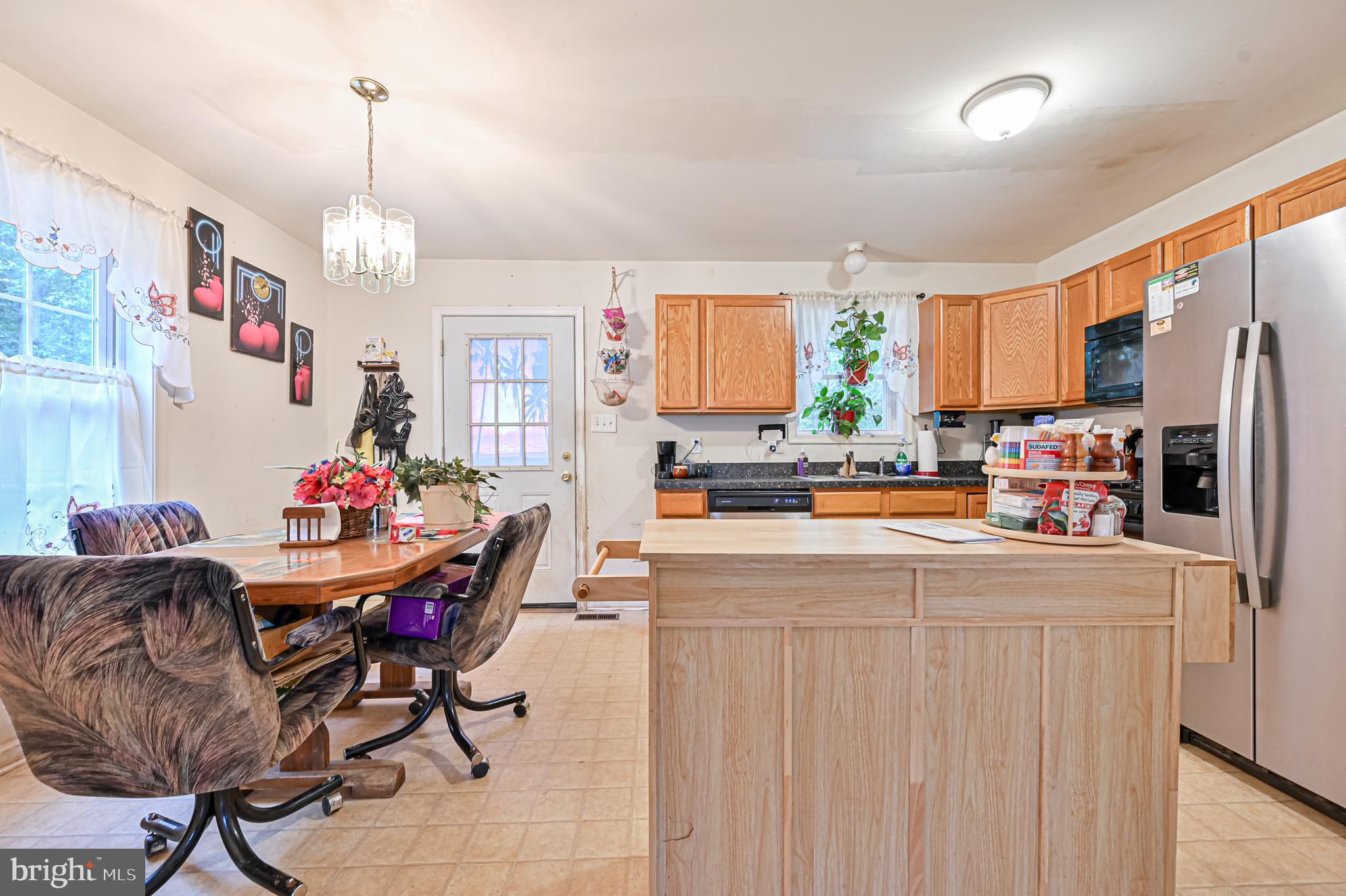 421 Evergreen Road Millville, NJ 08332 - Photo 5 of 26 a kitchen with stainless steel appliances kitchen island granite countertop a refrigerator and a dining table
