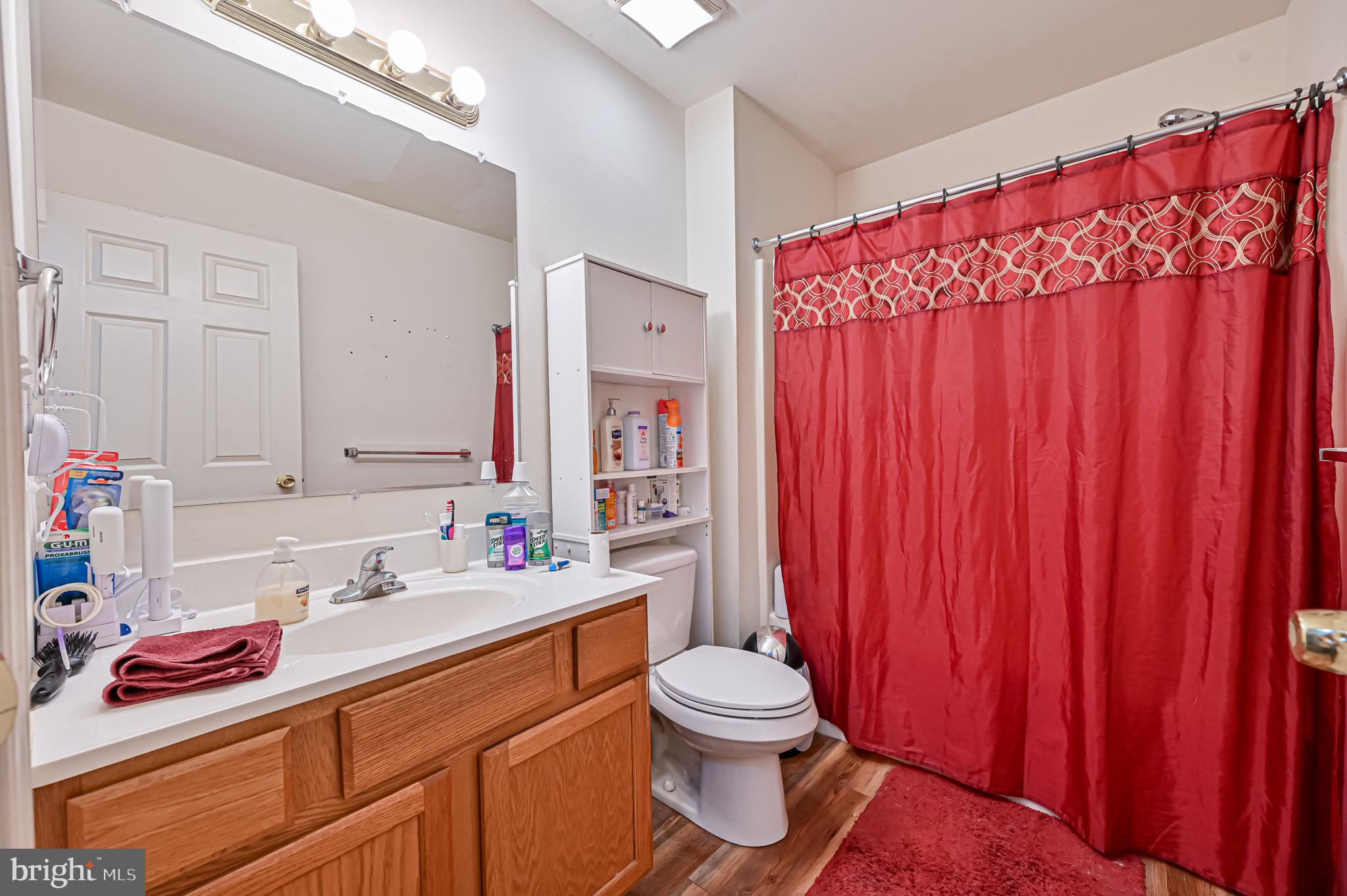 421 Evergreen Road Millville, NJ 08332 - Photo 10 of 26 a bathroom with a sink toilet and shower curtain