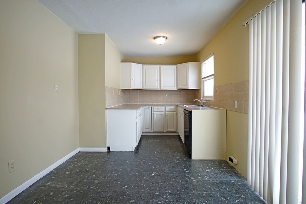 40 Old Farm Road Springfield, MA 01119 - Photo 5 of 16 a view of a kitchen with a sink and a refrigerator