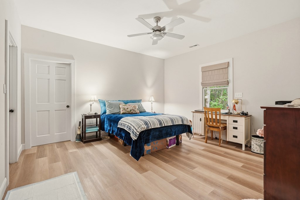 175 Crane Creek Road Young Harris, GA 30582 - Photo 19 of 40 a bedroom with a bed and a chandelier