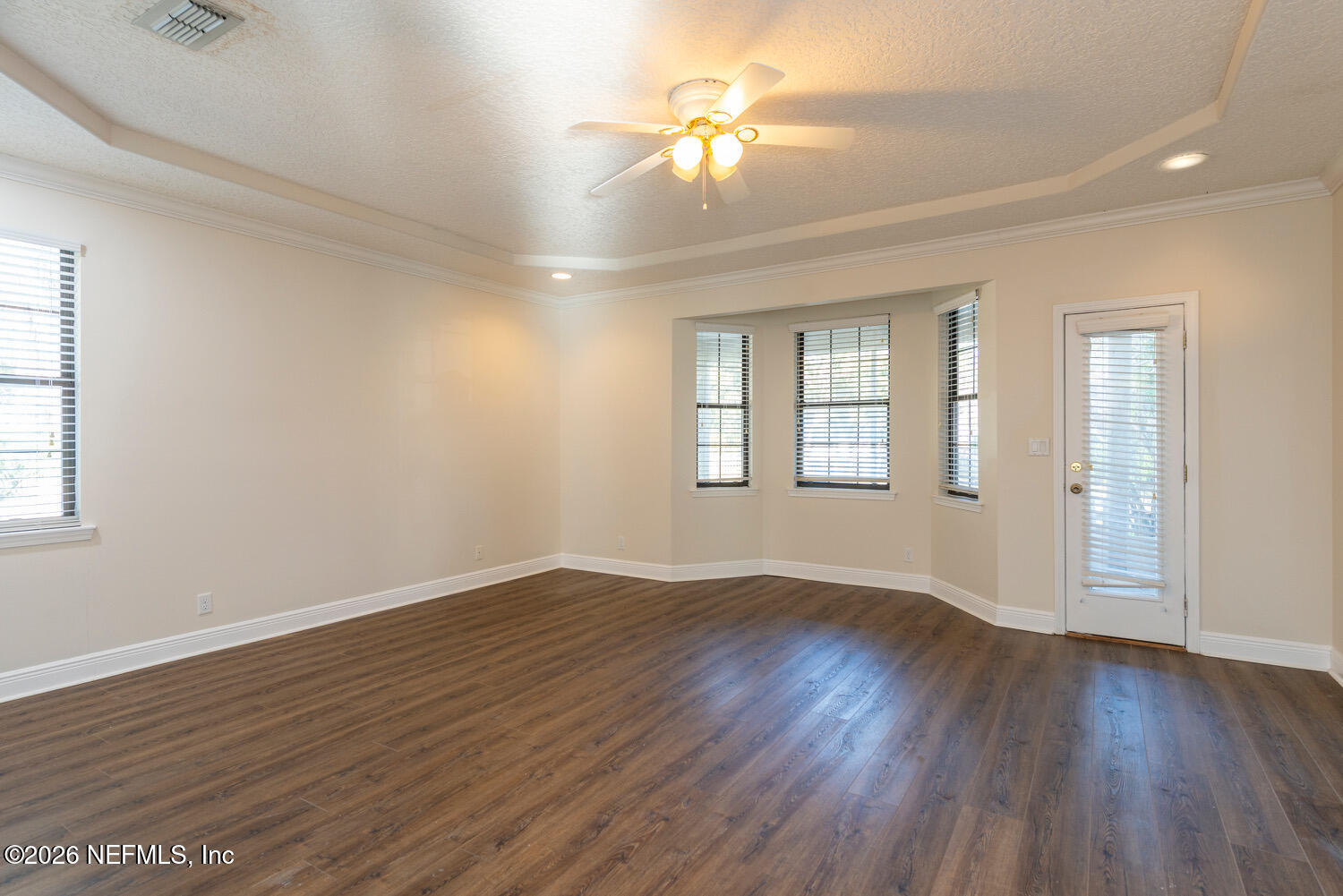 1467 Tama-Ran Place Fruit Cove, FL 32259 - Photo 8 of 22 an empty room with wooden floor chandelier fan and windows