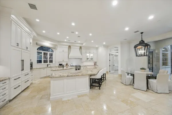a kitchen with stainless steel appliances granite countertop a sink stove and cabinets