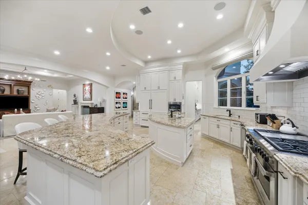a living room with fireplace furniture and a large window