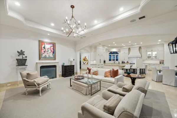 a living room with furniture and a chandelier