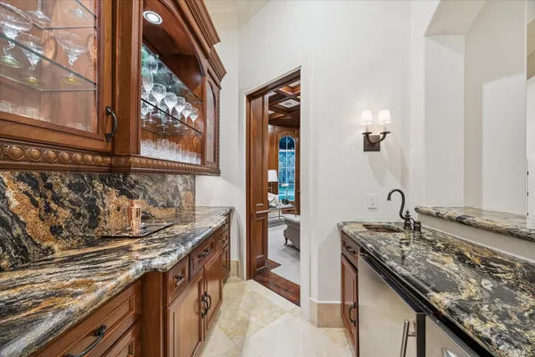 a kitchen with granite countertop a sink and a stove