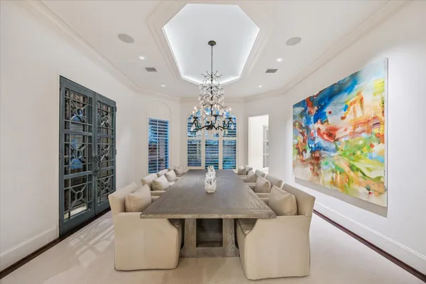a dining room with furniture a chandelier and window