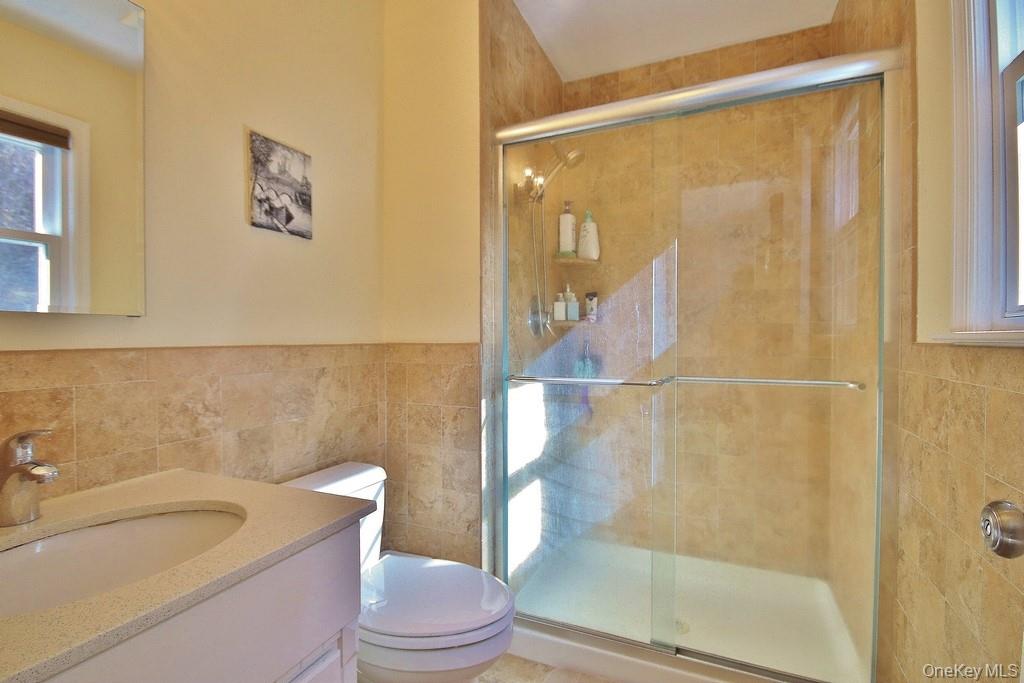 7 Farview Road Hopewell Junction, NY 12533 - Photo 24 of 32 a bathroom with a granite countertop bathtub shower sink mirror vanity and toilet