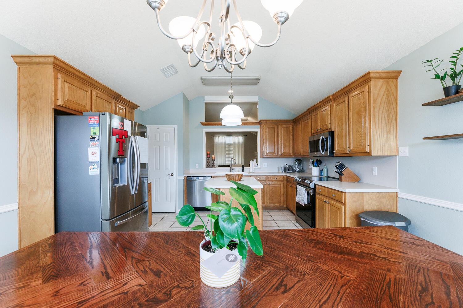 5504 101st Street Lubbock, TX 79424 - Photo 16 of 50 a bedroom with bed and a chandelier