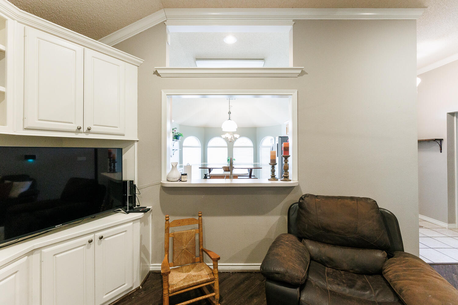 5504 101st Street Lubbock, TX 79424 - Photo 17 of 50 a living room with a couch and a stove next to a window