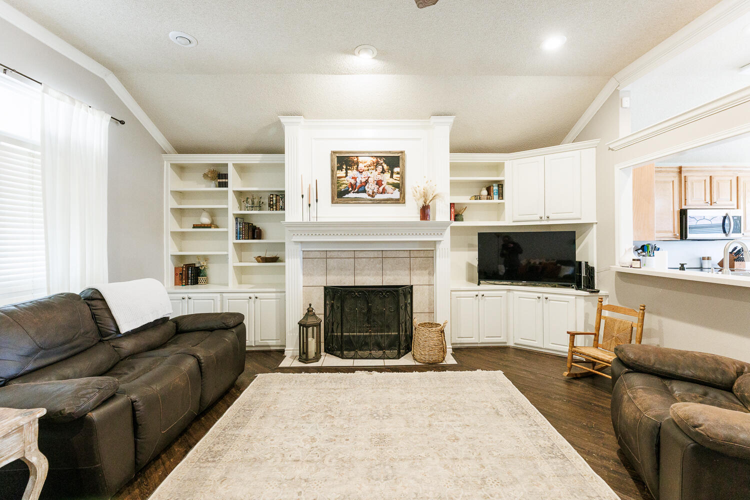 5504 101st Street Lubbock, TX 79424 - Photo 19 of 50 a living room with furniture and a fireplace