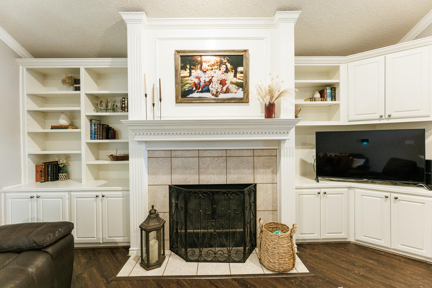 5504 101st Street Lubbock, TX 79424 - Photo 20 of 50 a living room with a fireplace and a flat screen tv
