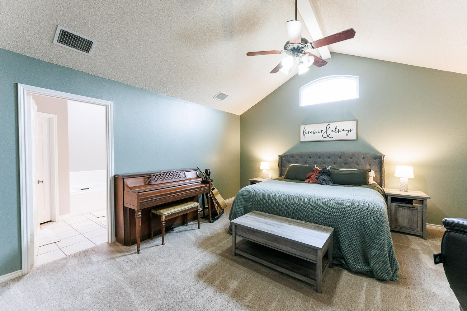 5504 101st Street Lubbock, TX 79424 - Photo 26 of 50 a bedroom with a bed and a chandelier