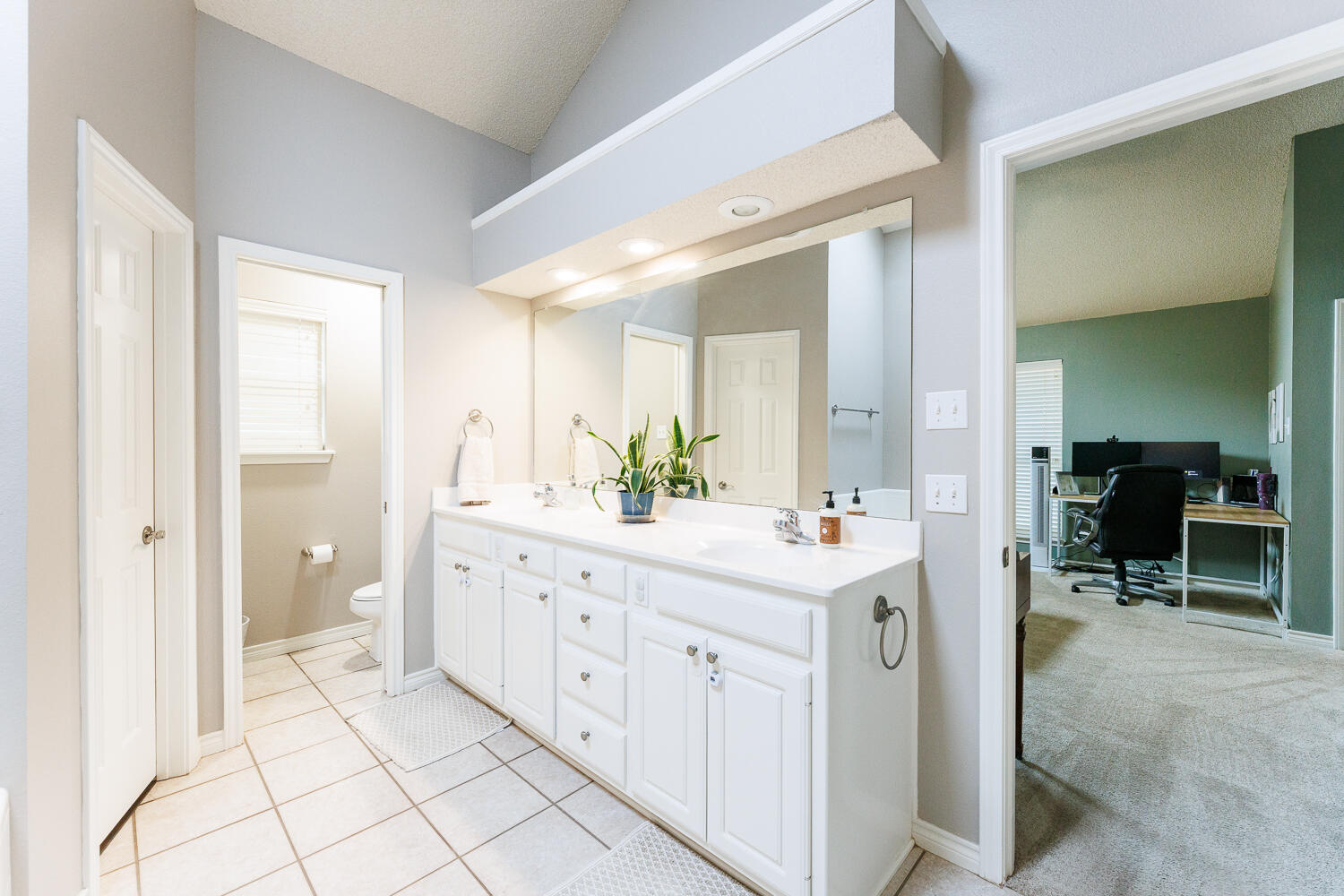 5504 101st Street Lubbock, TX 79424 - Photo 27 of 50 a spacious bathroom with a double vanity sink a mirror and a